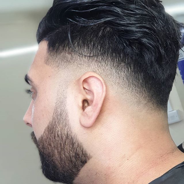 Drop fade with swept-back top and beard